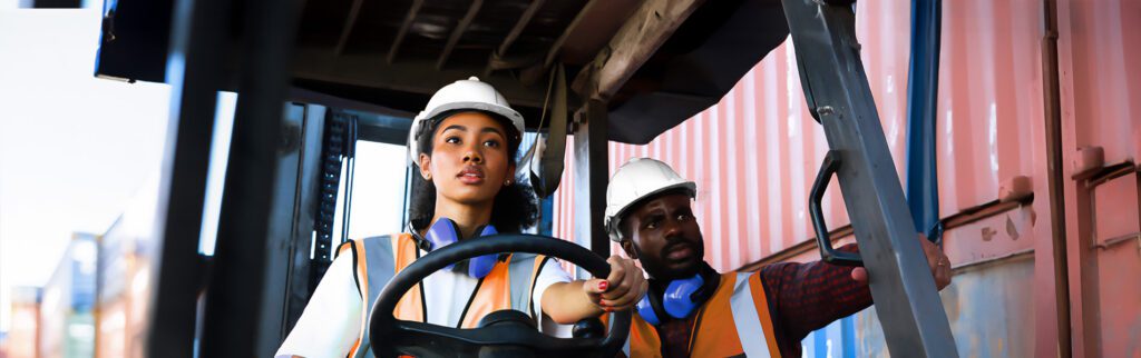 Safety supervisors undergoing forklift training at a job site.