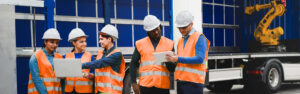 Group of safety professionals and engineers in a lab explore the role of technology in safety management and SafetyPlusWeb.