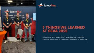 Three men in matching blue "Safety Plus" polos pose in their trade show booth at SEAA